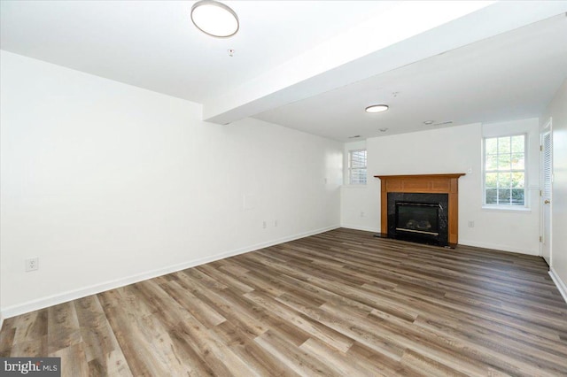 1806 Wheyfield Dr, Frederick, MD 21701 - unfurnished living room featuring plenty of natural light, wood finished floors, and a fireplace with flush hearth
