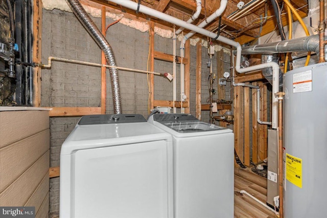 1806 Wheyfield Dr, Frederick, MD 21701 - laundry area featuring gas water heater, washer and dryer, concrete block wall, and wood finished floors