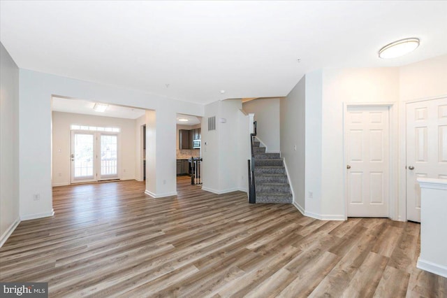 1806 Wheyfield Dr, Frederick, MD 21701 - unfurnished living room with light wood-style flooring and stairway
