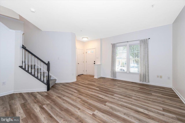 1806 Wheyfield Dr, Frederick, MD 21701 - unfurnished living room with wood finished floors and stairs