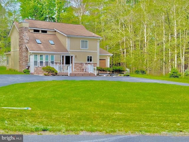 111 Sir Lyonnesse Ct, Blakeslee, PA 18610 - view of front facade featuring stone siding, a front yard, driveway, and a chimney
