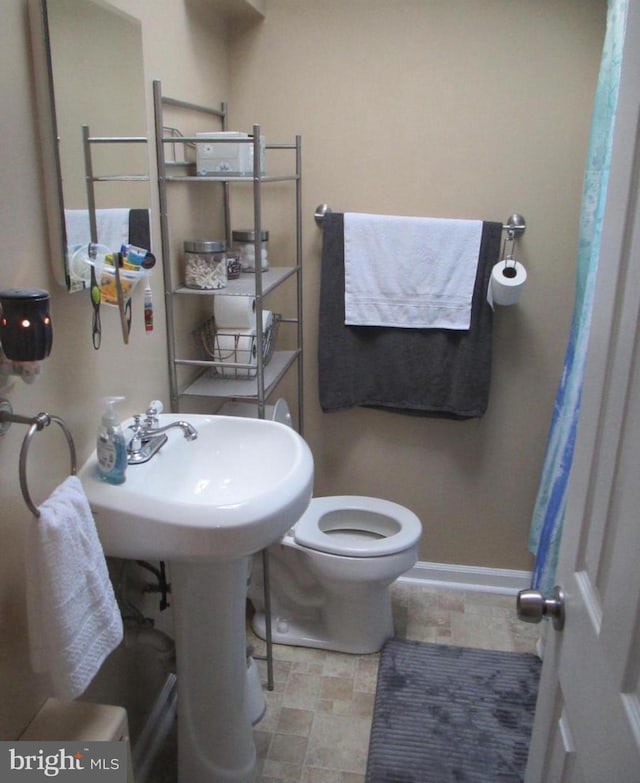 3642 Clarenell Rd, Baltimore, MD 21229 - bathroom with toilet and stone finish flooring