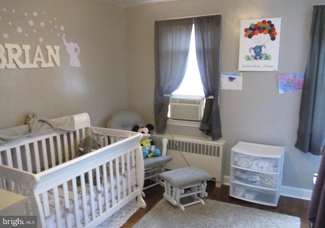 3642 Clarenell Rd, Baltimore, MD 21229 - bedroom with radiator, a nursery area, cooling unit, and wood finished floors