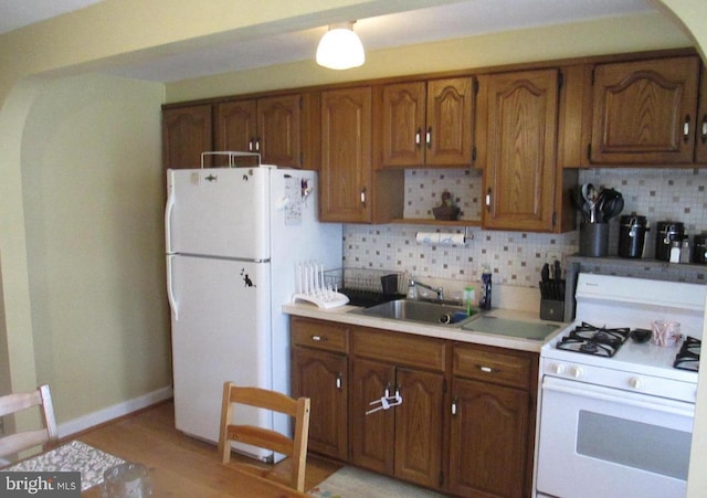 3642 Clarenell Rd, Baltimore, MD 21229 - kitchen featuring white appliances, decorative backsplash, and light countertops