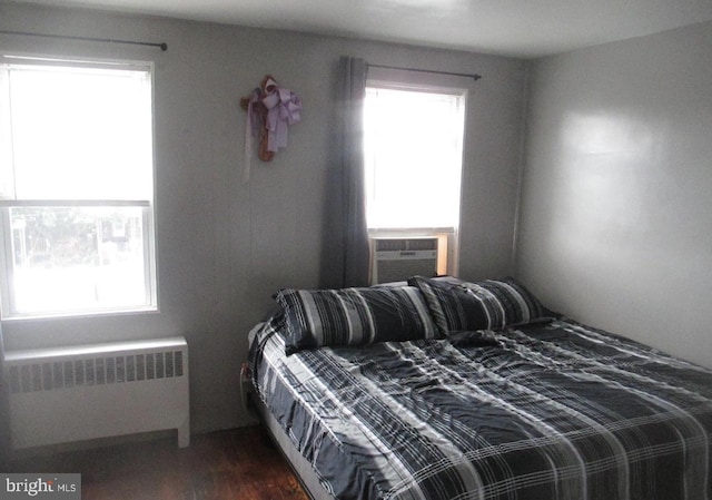 3642 Clarenell Rd, Baltimore, MD 21229 - bedroom with radiator, cooling unit, and dark wood-style flooring