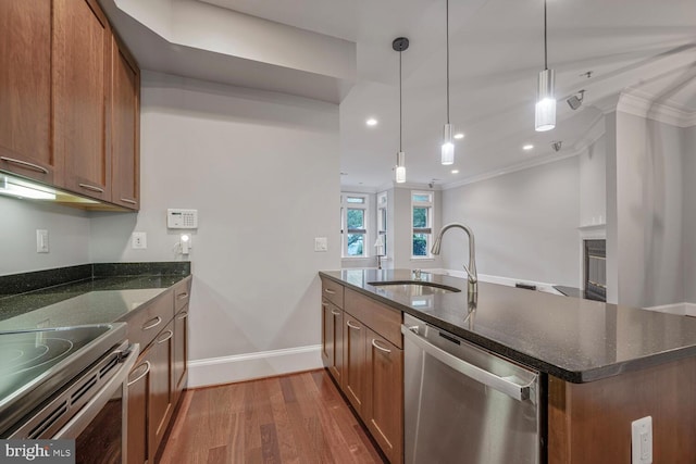 1817 6th St NW Unit A, Washington, DC 20001 - kitchen featuring dishwasher, wood finished floors, crown molding, dark stone countertops, and brown cabinetry