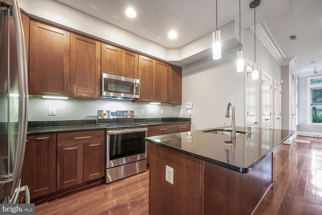 1817 6th St NW Unit A, Washington, DC 20001 - kitchen with appliances with stainless steel finishes, ornamental molding, dark wood-style flooring, dark stone countertops, and a center island with sink