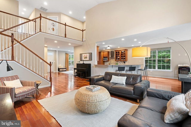 420 E Cottage Ave, Haddonfield, NJ 08033 - living room featuring wood finished floors, stairway, a high ceiling, and recessed lighting