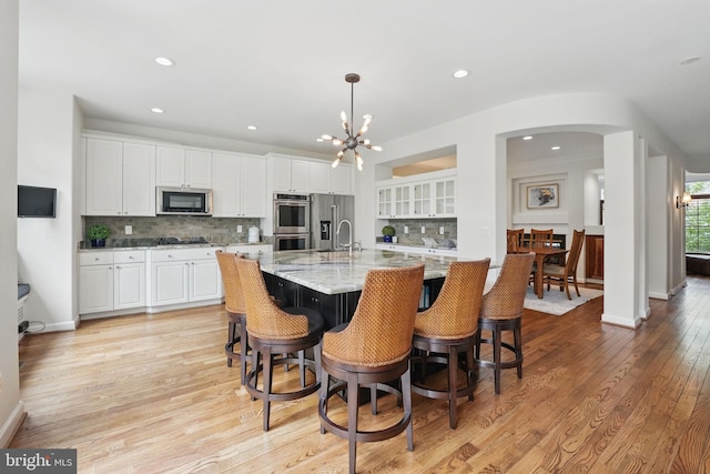 2119 21st Rd N, Arlington, VA 22201 - kitchen with stainless steel appliances, a chandelier, white cabinetry, decorative backsplash, and recessed lighting