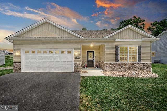 910 Cavalry St, Carlisle, PA 17013 - view of front of home featuring stone siding, asphalt driveway, board and batten siding, and an attached garage
