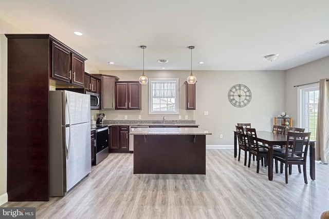 910 Cavalry St, Carlisle, PA 17013 - kitchen featuring stainless steel appliances, dark brown cabinetry, a kitchen island, light wood-type flooring, and recessed lighting