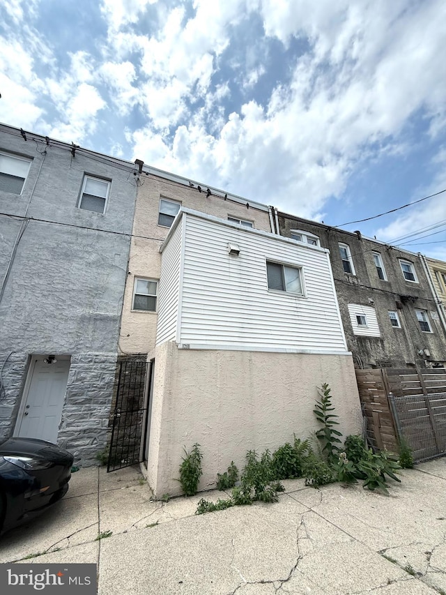 1611 S 28th St, Philadelphia, PA 19145 - view of home's exterior featuring stucco siding and a gate