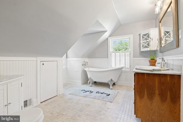 3834 Druck Valley Rd, York, PA 17406 - full bath featuring vanity, wainscoting, a freestanding tub, lofted ceiling, and tile patterned floors