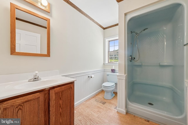 249 Mattson Rd, Garnet Valley, PA 19060 - bathroom with wood finished floors, a stall shower, vanity, crown molding, and a wainscoted wall