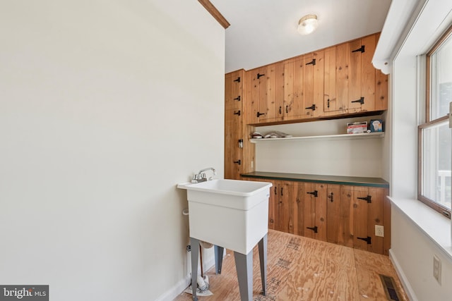 249 Mattson Rd, Garnet Valley, PA 19060 - laundry area featuring wood finished floors and baseboards