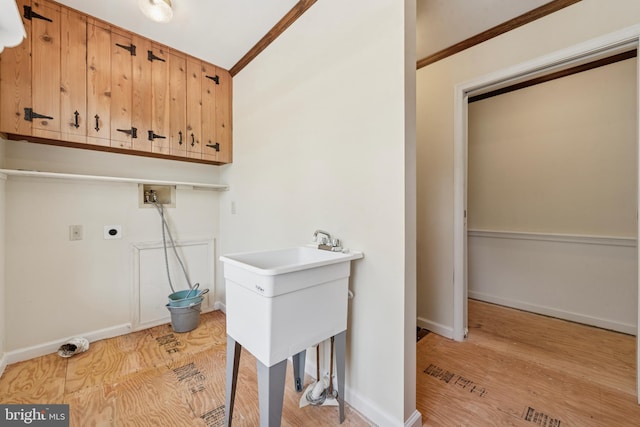 249 Mattson Rd, Garnet Valley, PA 19060 - laundry room with cabinet space, washer hookup, ornamental molding, light wood-type flooring, and hookup for an electric dryer