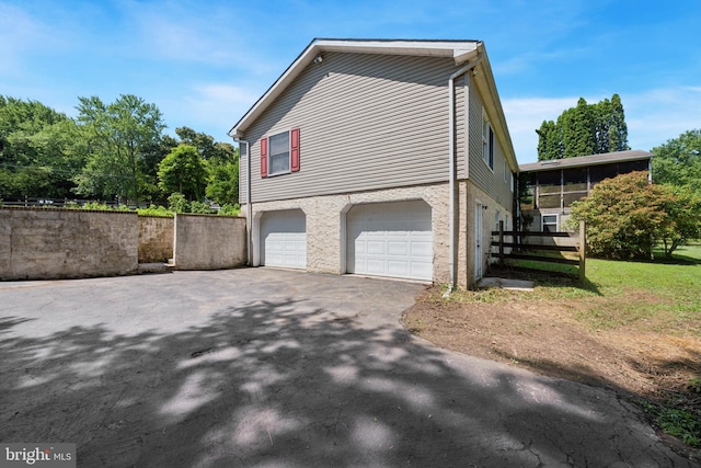 249 Mattson Rd, Garnet Valley, PA 19060 - view of property exterior with driveway, a garage, and a sunroom