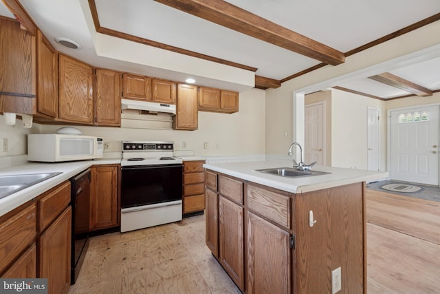 249 Mattson Rd, Garnet Valley, PA 19060 - kitchen with white appliances, under cabinet range hood, brown cabinets, light countertops, and light wood-type flooring