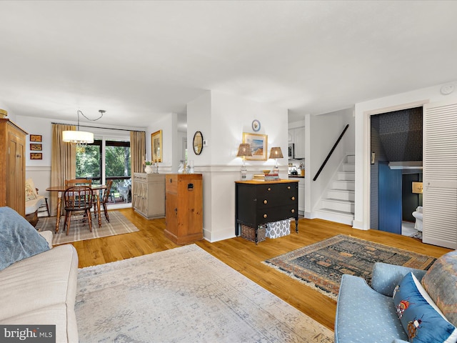 285 Laguna Cir, Severna Park, MD 21146 - living room with light wood-style flooring, stairway, and wainscoting
