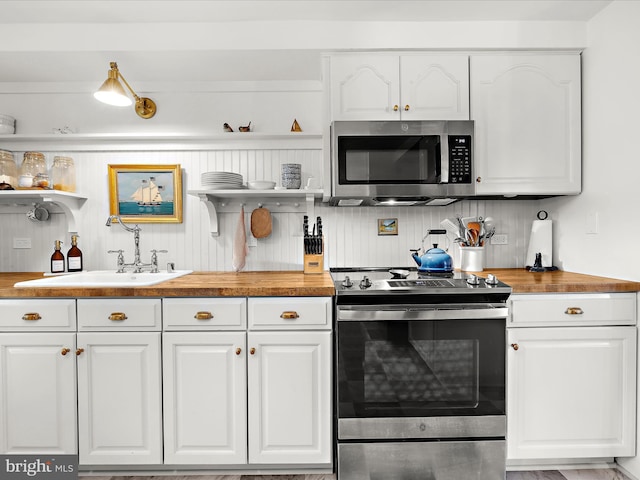 285 Laguna Cir, Severna Park, MD 21146 - kitchen with appliances with stainless steel finishes, open shelves, and butcher block counters