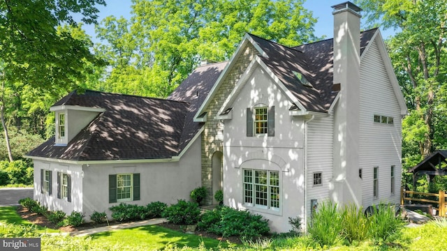 2109 Main St, Bethlehem, PA 18017 - view of property exterior featuring stucco siding, a chimney, and a shingled roof