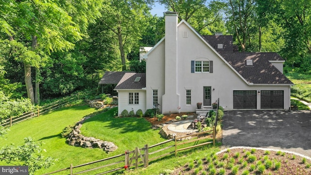 2109 Main St, Bethlehem, PA 18017 - view of front facade featuring driveway, a chimney, an attached garage, a shingled roof, and view of scattered trees