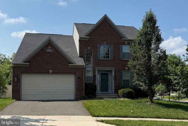 9204 Eason St, Glenarden, MD 20706 - view of front of property featuring brick siding, driveway, a garage, a front lawn, and roof with shingles