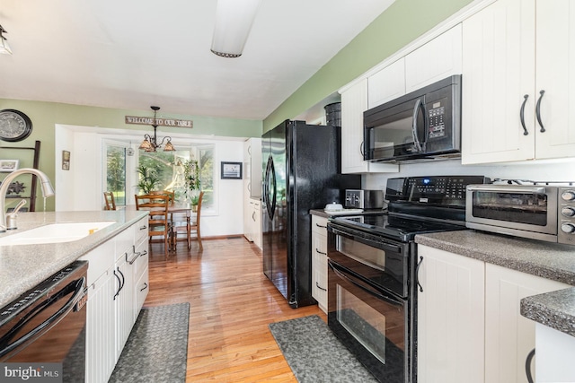 21 Black Bass, Fairfield, PA 17320 - kitchen with black appliances, white cabinetry, light wood-style floors, and pendant lighting