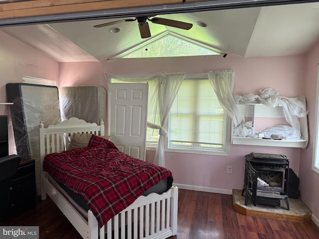 4 Brook Ramble Ln, Townsend, DE 19734 - bedroom with lofted ceiling, a wood stove, wood finished floors, and a ceiling fan