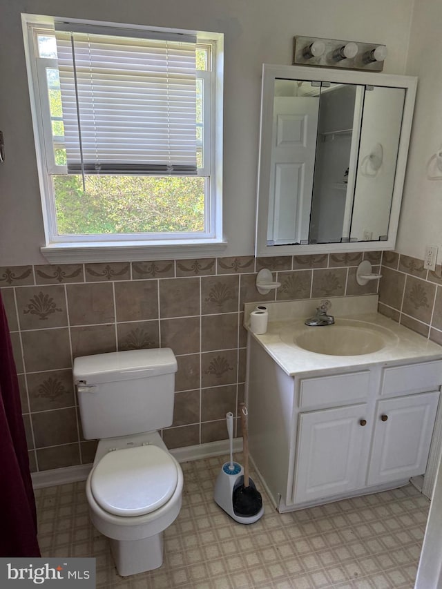 4 Brook Ramble Ln, Townsend, DE 19734 - bathroom featuring vanity, tile walls, tile patterned floors, and wainscoting