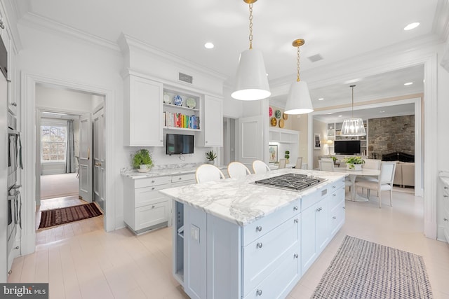 2950 Chain Bridge Rd NW, Washington, DC 20016 - kitchen with stainless steel gas stovetop, open shelves, white cabinets, a kitchen island, and crown molding