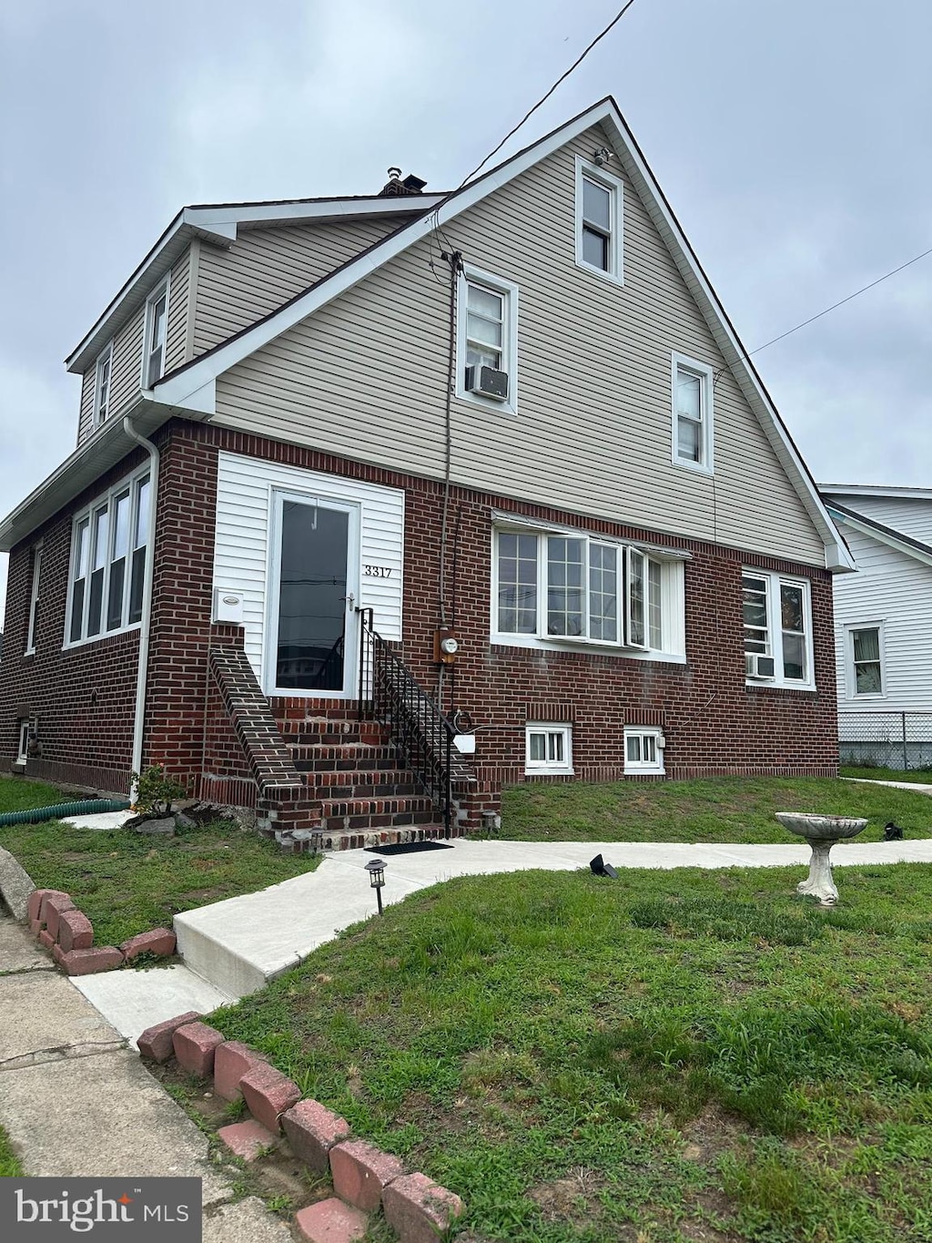 3317 Pelham Pl, Camden, NJ 08105 - view of front of home featuring a front lawn, brick siding, and cooling unit