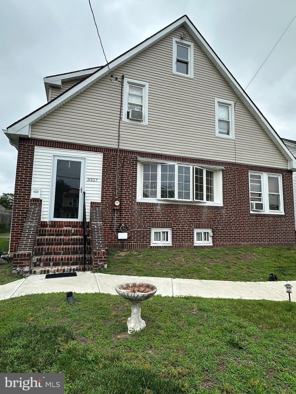 3317 Pelham Pl, Camden, NJ 08105 - view of front of home featuring a front yard, entry steps, cooling unit, and brick siding