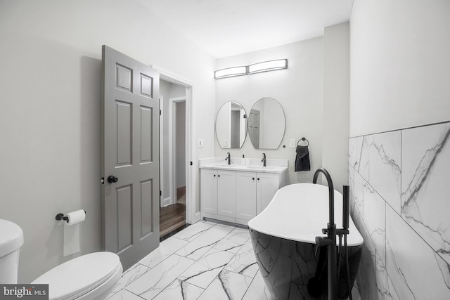 812 N Patterson Park Ave, Baltimore, MD 21205 - full bathroom featuring marble look tile flooring, a freestanding bath, and double vanity