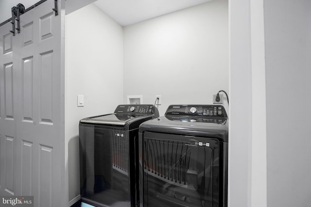 812 N Patterson Park Ave, Baltimore, MD 21205 - laundry room with washer and clothes dryer and a barn door