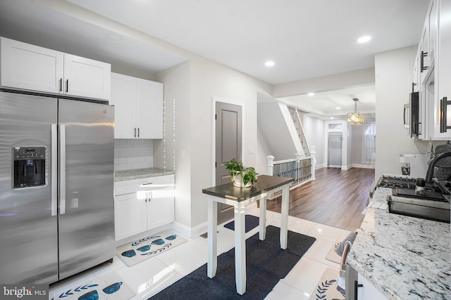 812 N Patterson Park Ave, Baltimore, MD 21205 - kitchen with appliances with stainless steel finishes, light tile patterned flooring, white cabinetry, recessed lighting, and decorative backsplash