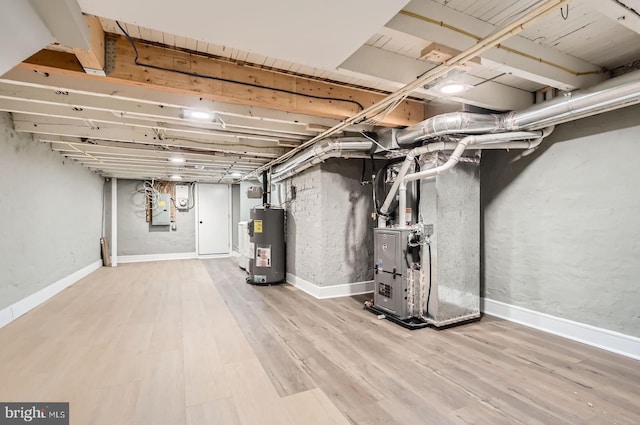 3621 Chestnut Ave, Baltimore, MD 21211 - unfinished basement featuring electric water heater, heating unit, wood finished floors, and electric panel
