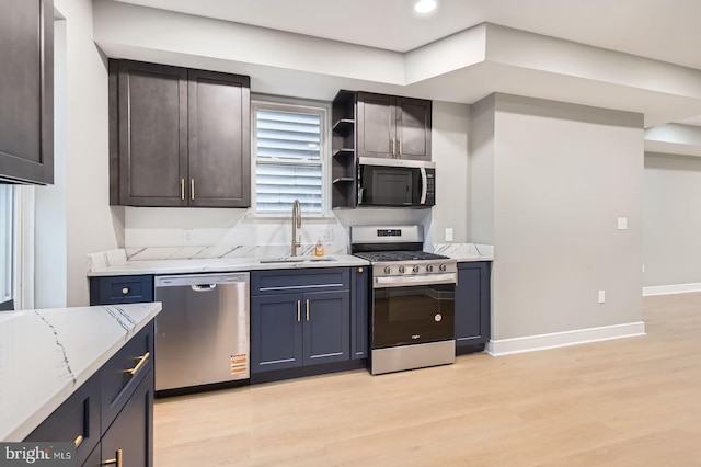 3621 Chestnut Ave, Baltimore, MD 21211 - kitchen featuring appliances with stainless steel finishes, light wood-style floors, light stone countertops, open shelves, and recessed lighting