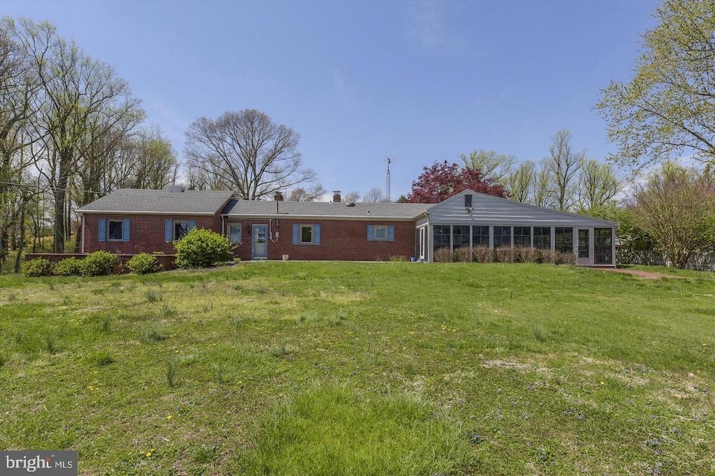 29341 Glencoe Rd, Kennedyville, MD 21645 - view of front of home with a sunroom, brick siding, a front lawn, and a chimney