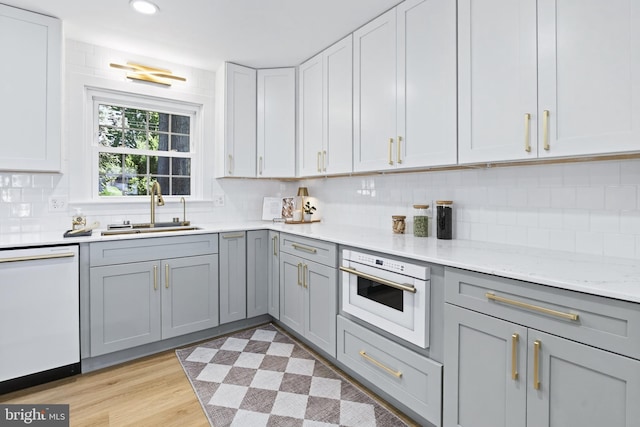 341 Ashford Dr, Lancaster, PA 17601 - kitchen featuring white appliances, gray cabinetry, tasteful backsplash, light stone countertops, and recessed lighting