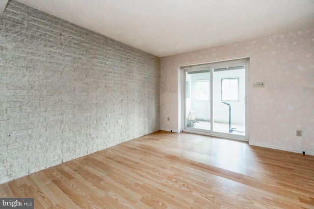 2057 Grove St, Allentown, PA 18104 - unfurnished room with wood finished floors and brick wall