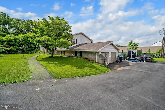 2057 Grove St, Allentown, PA 18104 - view of front of home with an attached garage, a front lawn, driveway, brick siding, and a shingled roof