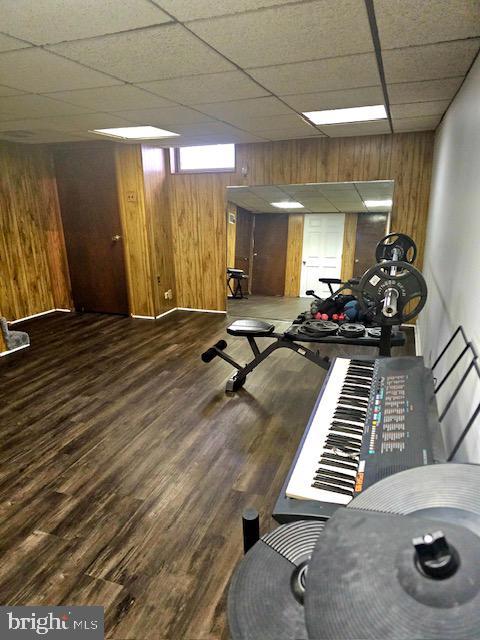 43 Briarcliffe Rd, Glenolden, PA 19036 - workout room with wood walls, wood finished floors, and a drop ceiling