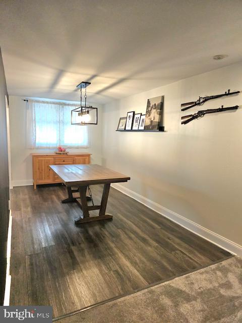 43 Briarcliffe Rd, Glenolden, PA 19036 - dining room featuring baseboards and dark wood-type flooring