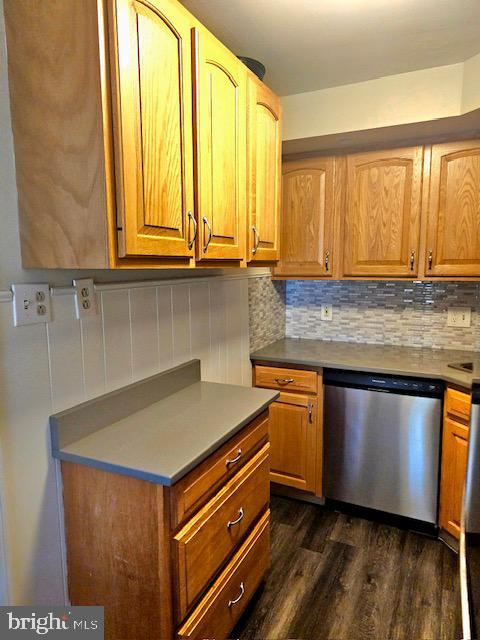 43 Briarcliffe Rd, Glenolden, PA 19036 - kitchen with dishwasher, dark wood finished floors, tasteful backsplash, and brown cabinetry