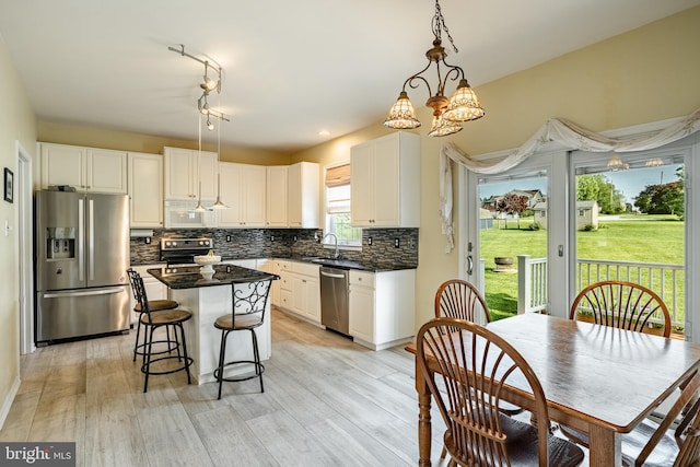 14 Burk Rd, Cochranville, PA 19330 - kitchen with appliances with stainless steel finishes, a center island, white cabinets, and tasteful backsplash