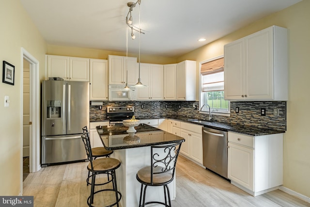 14 Burk Rd, Cochranville, PA 19330 - kitchen with stainless steel appliances, decorative backsplash, a kitchen island, dark stone counters, and white cabinets
