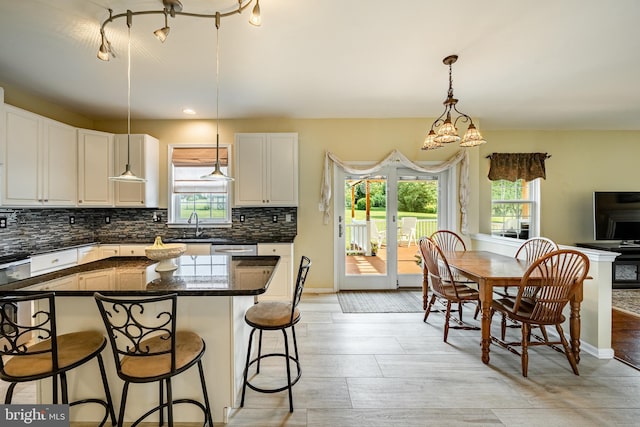 14 Burk Rd, Cochranville, PA 19330 - kitchen with backsplash, a breakfast bar area, white cabinetry, and pendant lighting