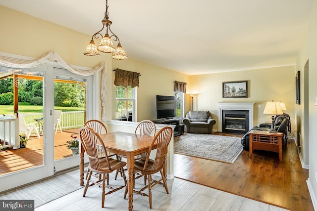 14 Burk Rd, Cochranville, PA 19330 - dining space with a fireplace with flush hearth, hardwood / wood-style floors, and a chandelier