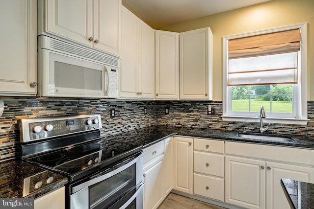 14 Burk Rd, Cochranville, PA 19330 - kitchen with double oven range, white microwave, decorative backsplash, dark stone counters, and white cabinets